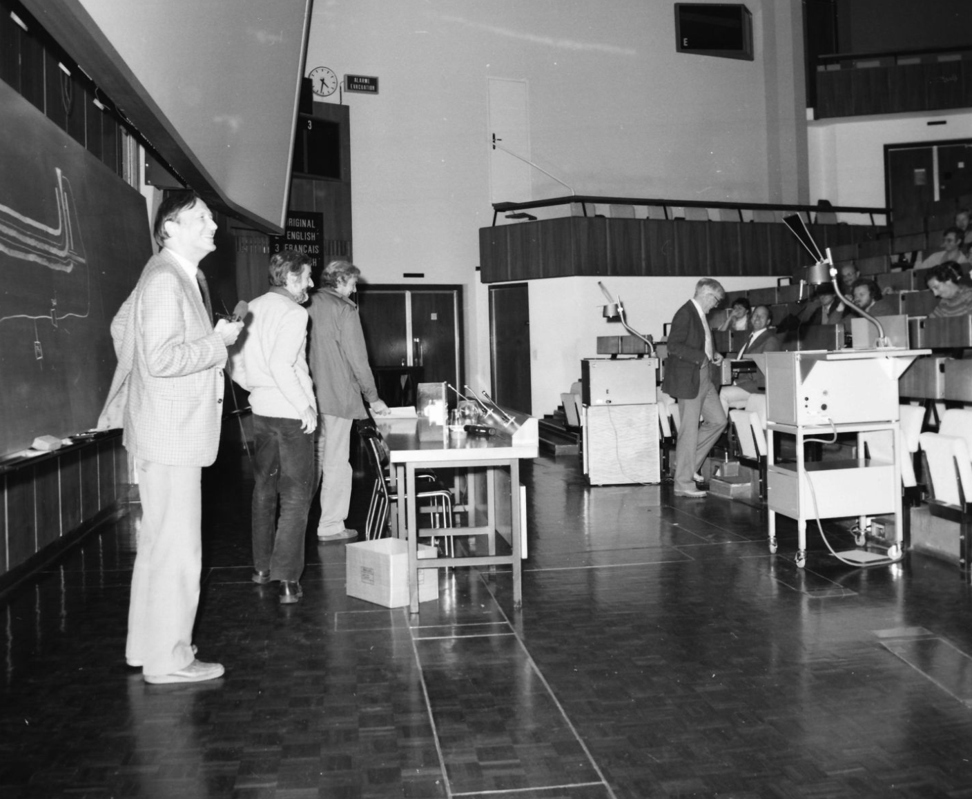 Simon van der Meer, Dieter Möhl and Colin Taylor near the blackboard during the first CAS in 1983